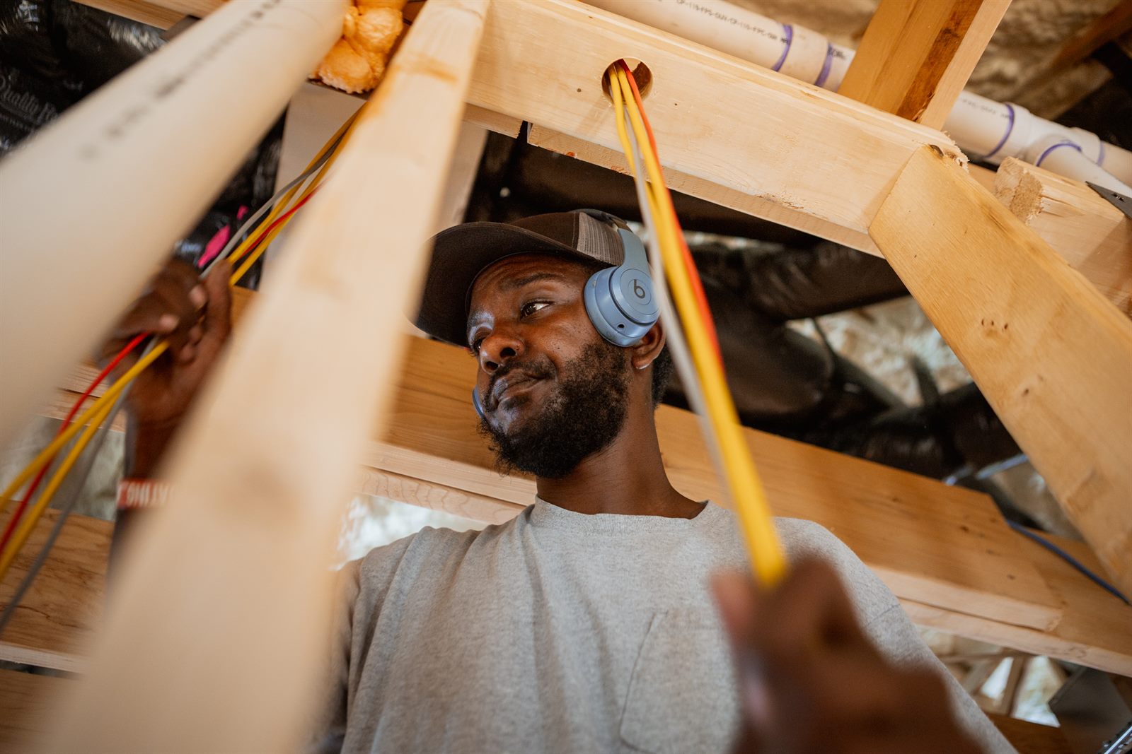 Secur-Tek technician pulling low-voltage cable during a new-construction pre-wire